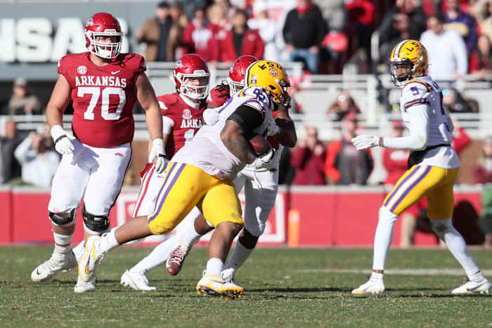 Nov 12, 2022; Fayetteville, Arkansas, USA; LSU Tigers defensive lineman Mekhi Wingo (92) recovers a fumble in the fourth quarter against the Arkansas Razorbacks at Donald W. Reynolds Razorback Stadium. LSU won 13-10. Mandatory Credit: Nelson Chenault-USA TODAY Sports  